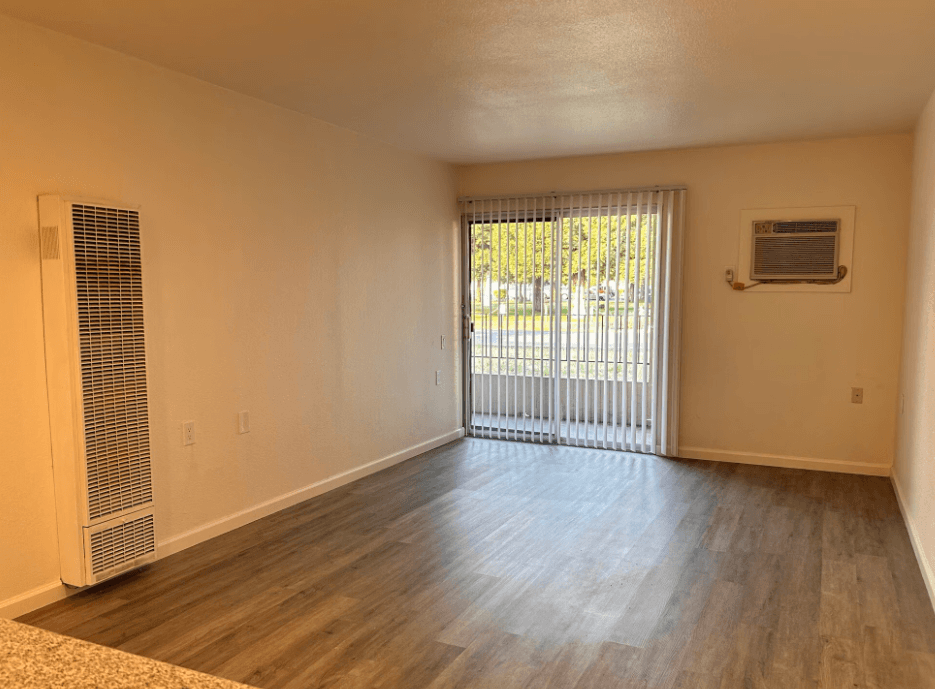 A room with a sliding glass door leading to a patio.